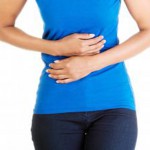 woman-in-blue-shirt-holding-stomach